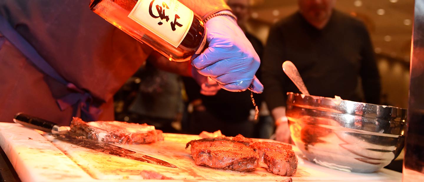Visitors enjoying gourmet food and fine wines at Sun Wine & Food Fest 2024 in Uncasville, CT, featuring celebrity chefs, wine tastings, and culinary demonstrations.